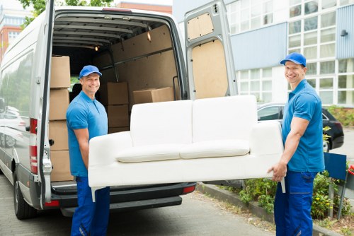 Furniture pick-up service removing a sofa in Bayswater