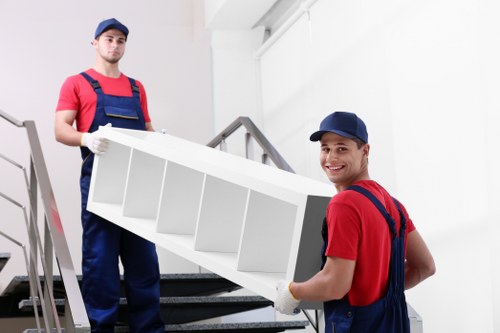 Specialist team safely moving a piano through a narrow Bayswater property