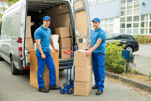 Movers carrying boxes into a flat in Bayswater